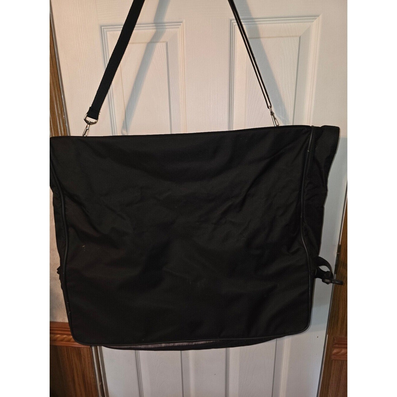 Black garment bag with shoulder strap