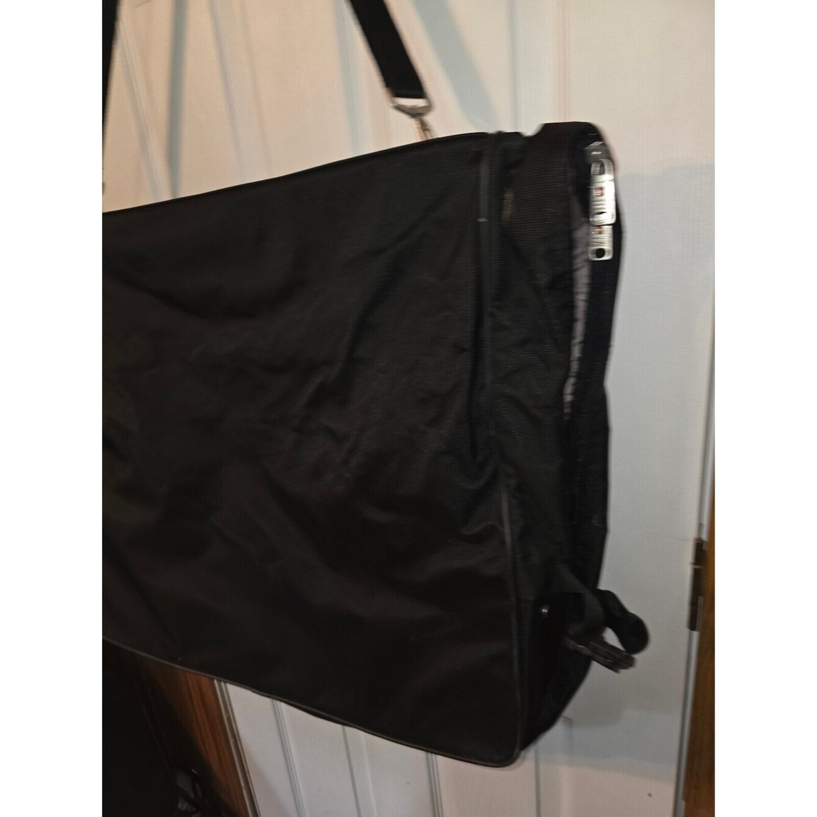 Black garment bag with shoulder strap